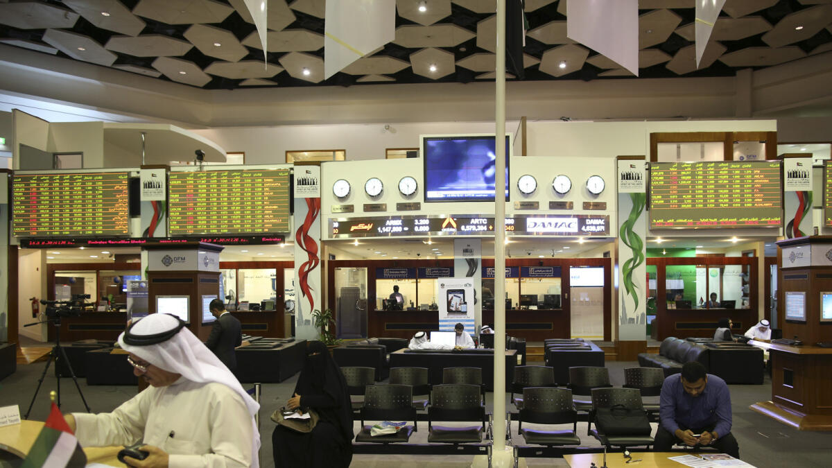 Traders work inside the Dubai Financial Market. Blue-chip stocks were the main drag on the bourse on Tuesday. 