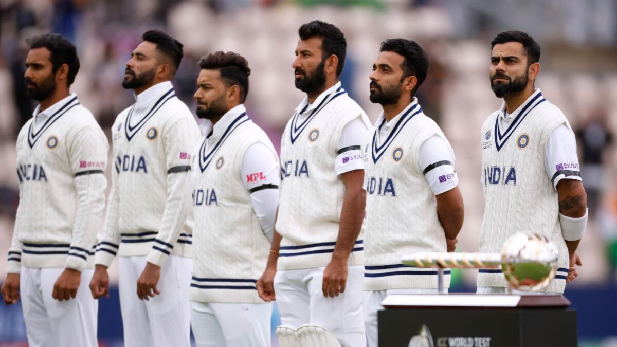 India's Virat Kohli and teammates lineup before play as they wear black armbands as a mark of respect for track legend Milkha Singh. — Reuters