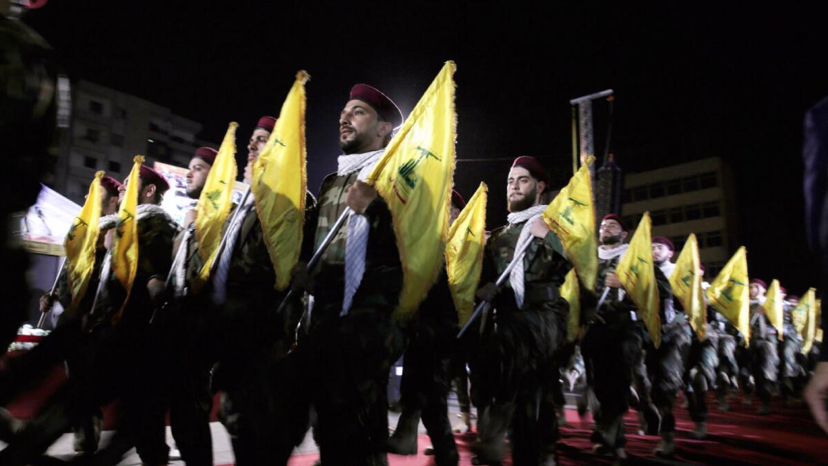 Hezbollah fighters march at a rally in Beirut. — AP file