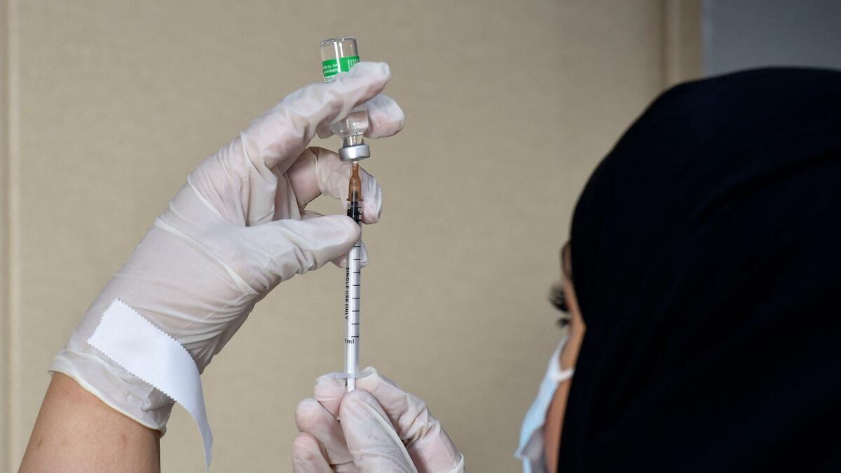 A medical worker prepares a dose of the AstraZeneca COVID-19 vaccine at a vaccination center in Riyadh. Photo: AFP