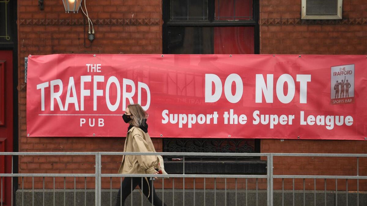A banner against the proposed European Super League hangs from a pub close to Manchester United's Old Trafford stadium in Manchester, northwest England on April 21, 2021. — AFP