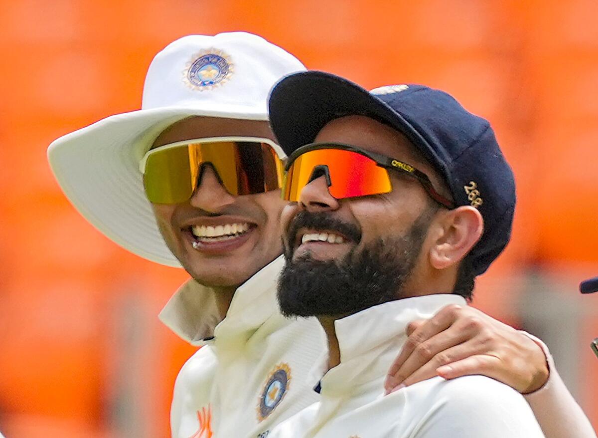 Indian cricketers Virat Kohli and Shubman Gill share a light moment during the fifth day of the fourth Test against Australia. — PTI