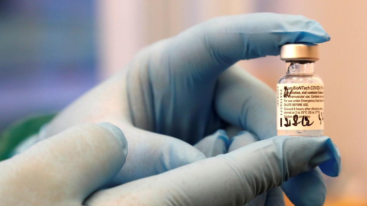 A medical worker holds Pfizer/BioNTech COVID-19 vaccine as Latvia begins vaccinations against the coronavirus disease (COVID-19), at the hospital in Ventspils, Latvia December 28, 2020.