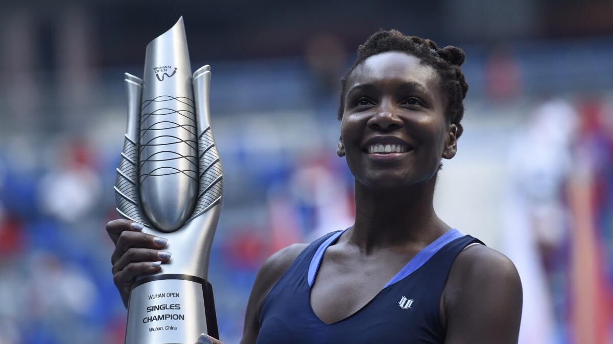Venus Williams poses with her trophy after defeating Spain’s Garbine Muguruza in the Wuhan Open final. 