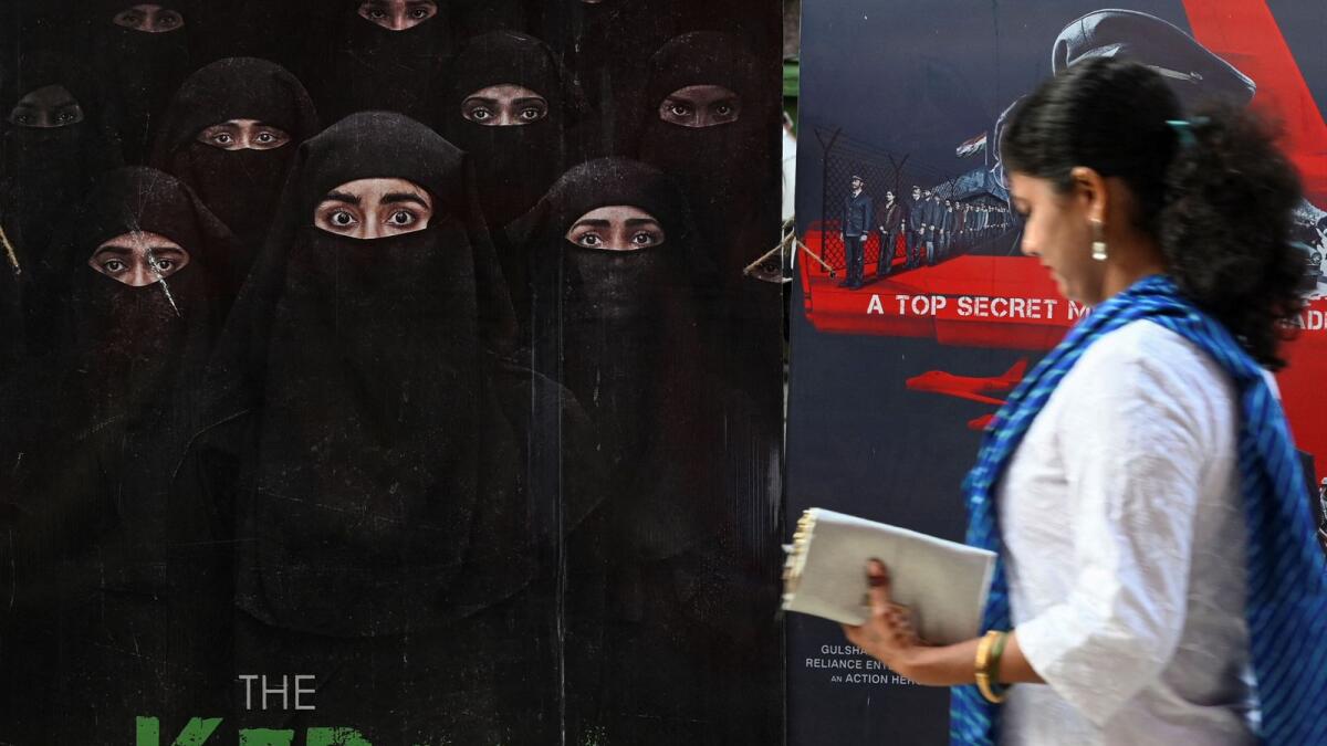A moviegoer walks past a poster of the film - The Kerala Story - at a movie theatre in Mumbai. — AFP