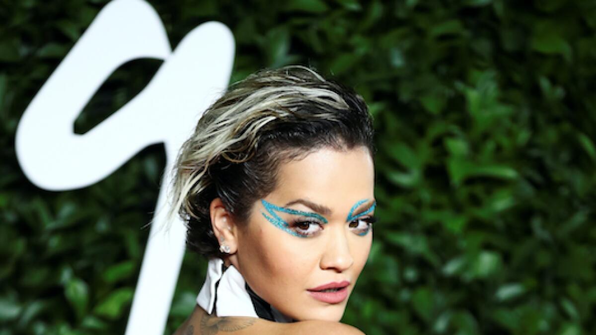 Rita Ora stood out in a black and white leather gown with sparkly eye makeup