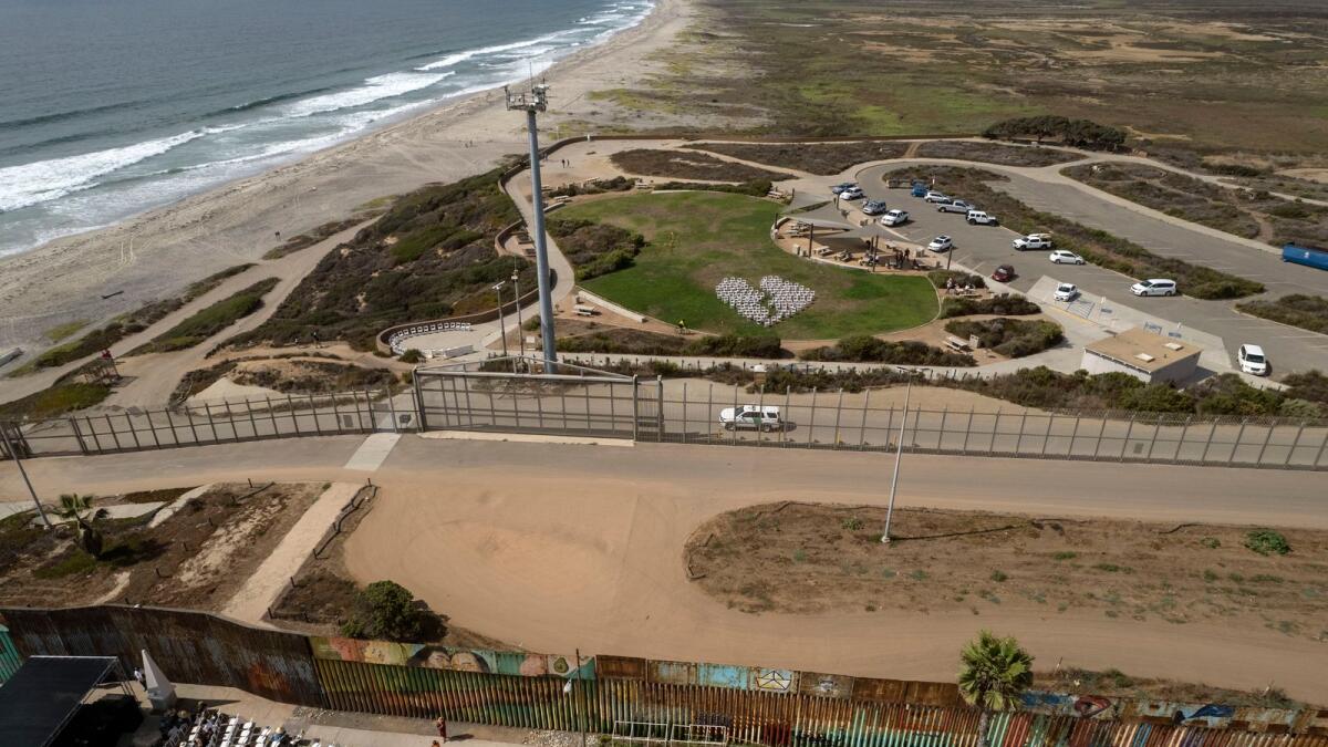Aerial view of both sides of the Friendship Park during its 51th anniversary celebrations at the border between US and Mexico in Playas de Tijuana, Mexico, on August 20, 2022. - The binational Friendship Park was inaugurated in 1971 by US First Lady Pat Nixon as California's Border Field State Park. (Photo by Guillermo Arias / AFP)
