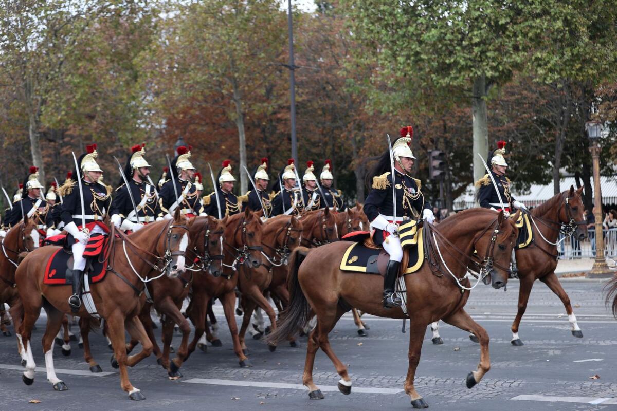 French Republican Guards ride their horses on the Champs-Elysees avenue upon the arrival of Britain's King Charles and Queen Camilla in Paris. Photo: Reuters