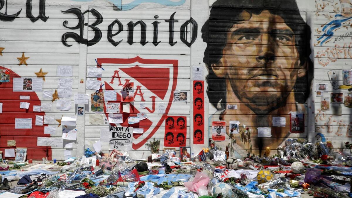 Floral tributes and shirts in honour of Diego Armando Maradona, in the aftermath of his death, outside the Diego Armando Maradona stadium in Buenos Aires, Argentina, November 27, 2020.