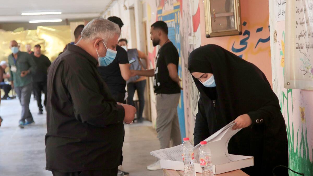 Iraqis voters cast their vote at a ballot station in the parliamentary elections in Baghdad. – AP