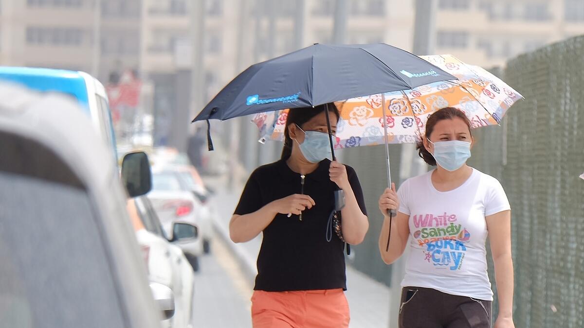 Residents take shelter from the sunny, dusty weather in Dubai. Photo by Shihab/KT