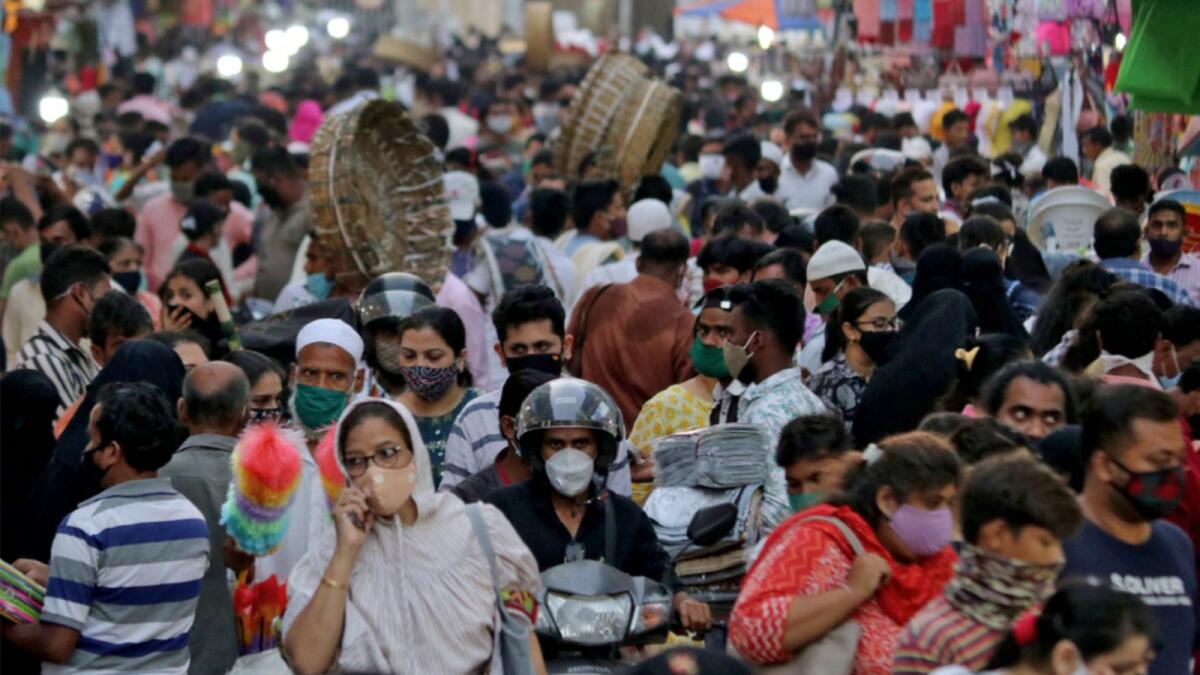 People wearing protective masks crowd a marketplace amidst the spread of Covid-19 in Mumbai. — Reuters