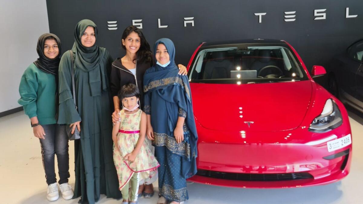 Fiji Sudheer with her children, and Aries Group chief happiness officer Nivedya Roy, after buying her dream electric car. Supplied photo