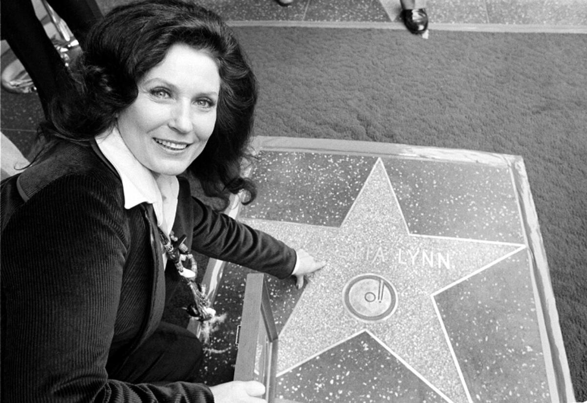 Country music singer Loretta Lynn points to her Hollywood Walk of Fame star during induction ceremonies in Hollywood, Calif., on Feb. 8, 1978
