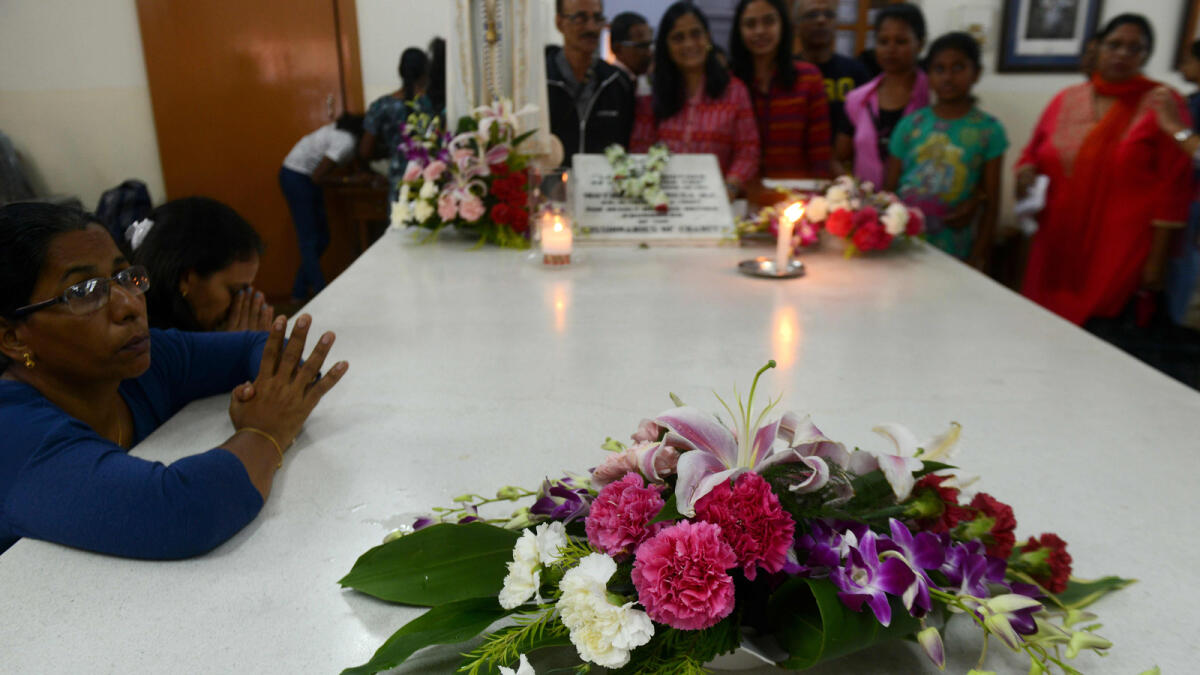 Indian devotees pray around the Mother's Tomb at the Missionaries of Charity House on the eve of the canonisation of Mother Teresa in Rome, in Kolkata on September 2, 2016. As the Vatican prepares to declare Mother Teresa a saint on September 4, in the Indian city where she rose to fame, claims of medical negligence and financial mismanagement at her care homes threaten to cloud her legacy/ AFP