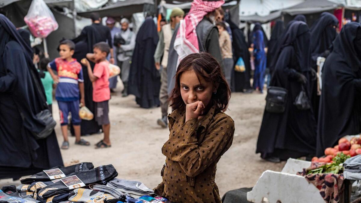 A girl stands next to stall selling socks at the Al Hol camp in Syria's northeastern Al-Hasakah Governorate, on October 10, 2023. — AFP