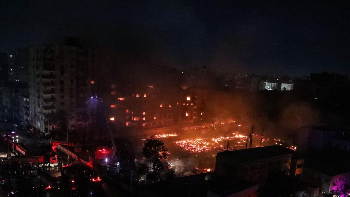 Firefighters battle the flames at Al Ahram Studio and surrounding buildings. — AFP