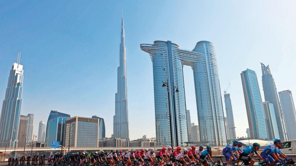 Welcome to Dubai: Riders pass by the Burj Khalifa during the Expo 2020 Dubai Stage of the UAE Tour on Friday. — Supplied photo