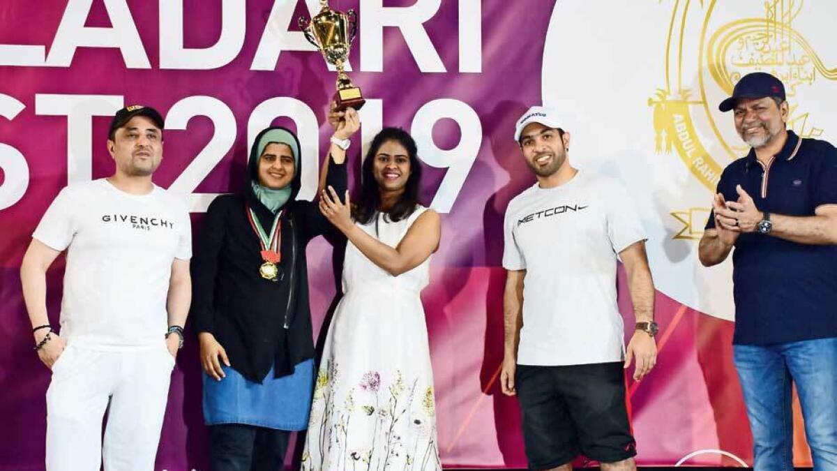 Saman Haziq and Priyanka Venugopal, winners in Women Badminton doubles accept the trophy.- Photo by Shihab/Khaleej Times