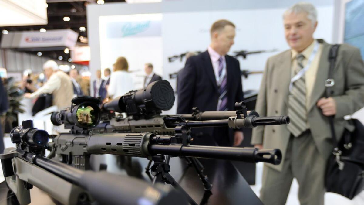 Idex visitors look on the Sniper rifle display at Kalashnikov Group Pavilion. 