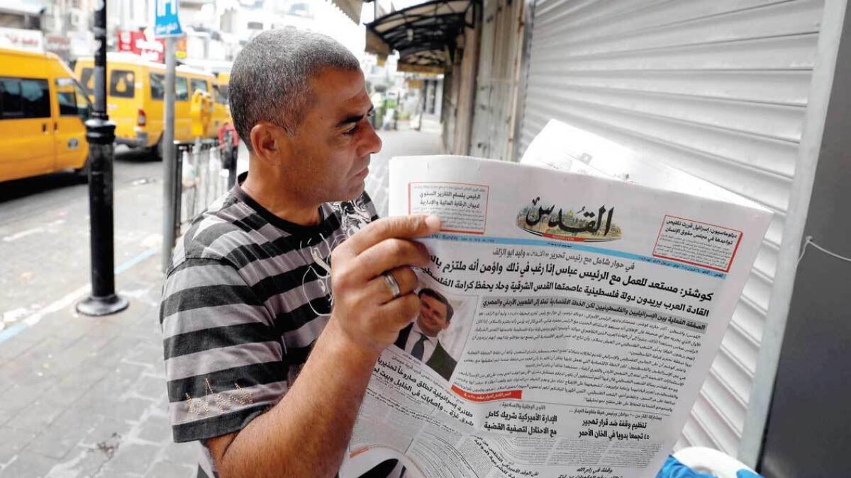 A man reads Al Quds that published an interview with Jared Kushner, in Ramallah on Sunday. — Reuters