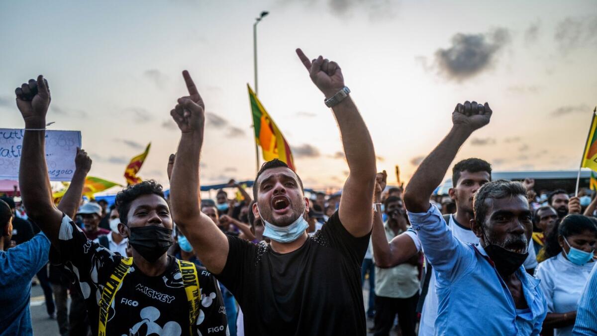 Protesters shout slogans during anti-government demonstration in Colombo. – AFP