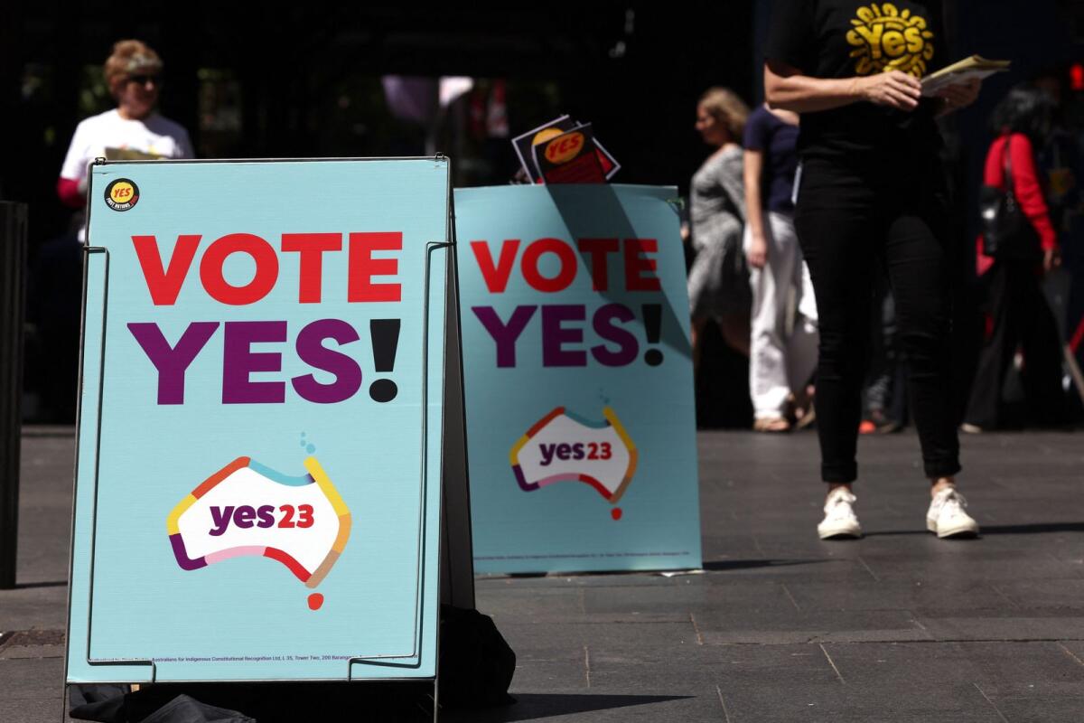 A group of ‘YES23’ campaign volunteers hand out pamphlets next to promotional referendum posters in central Sydney on October 9, 2023. — AFP