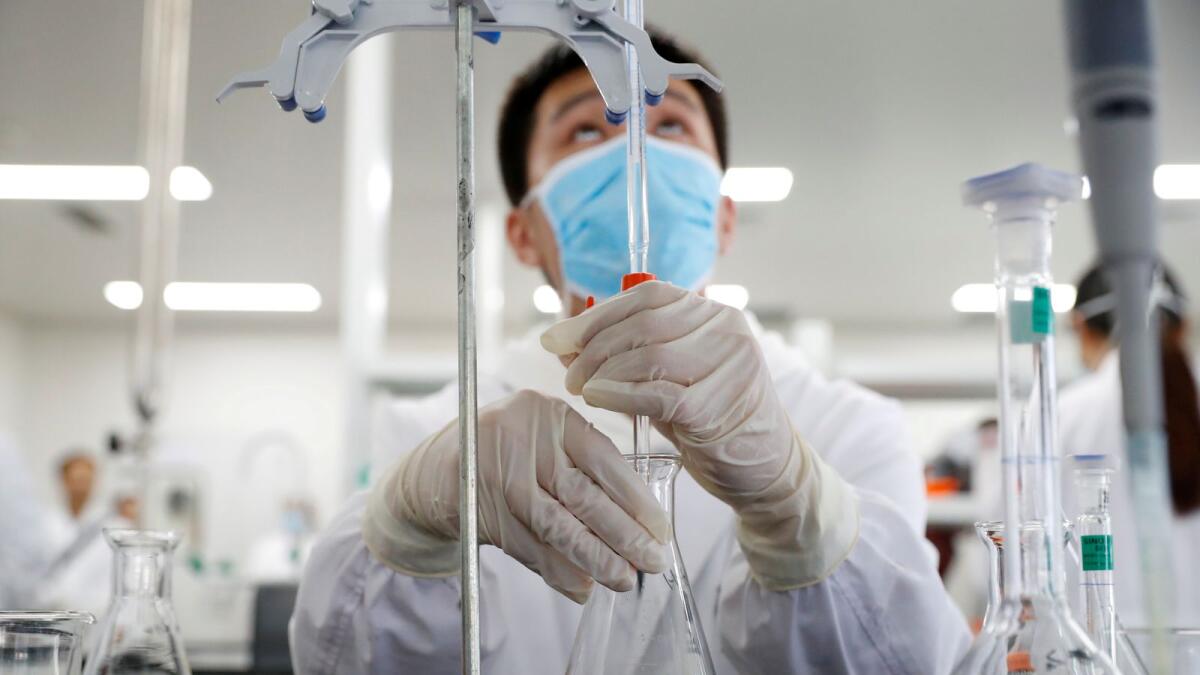 A man works in a laboratory of Chinese vaccine maker Sinovac Biotech, developing in Beijing, China, September 24, 2020.