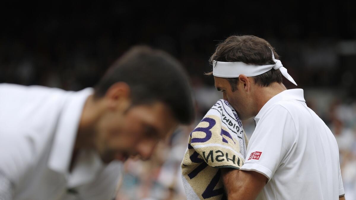 Novak Djokovic and Roger Federer during the men's singles final match of the Wimbledon Tennis Championships in London. AP