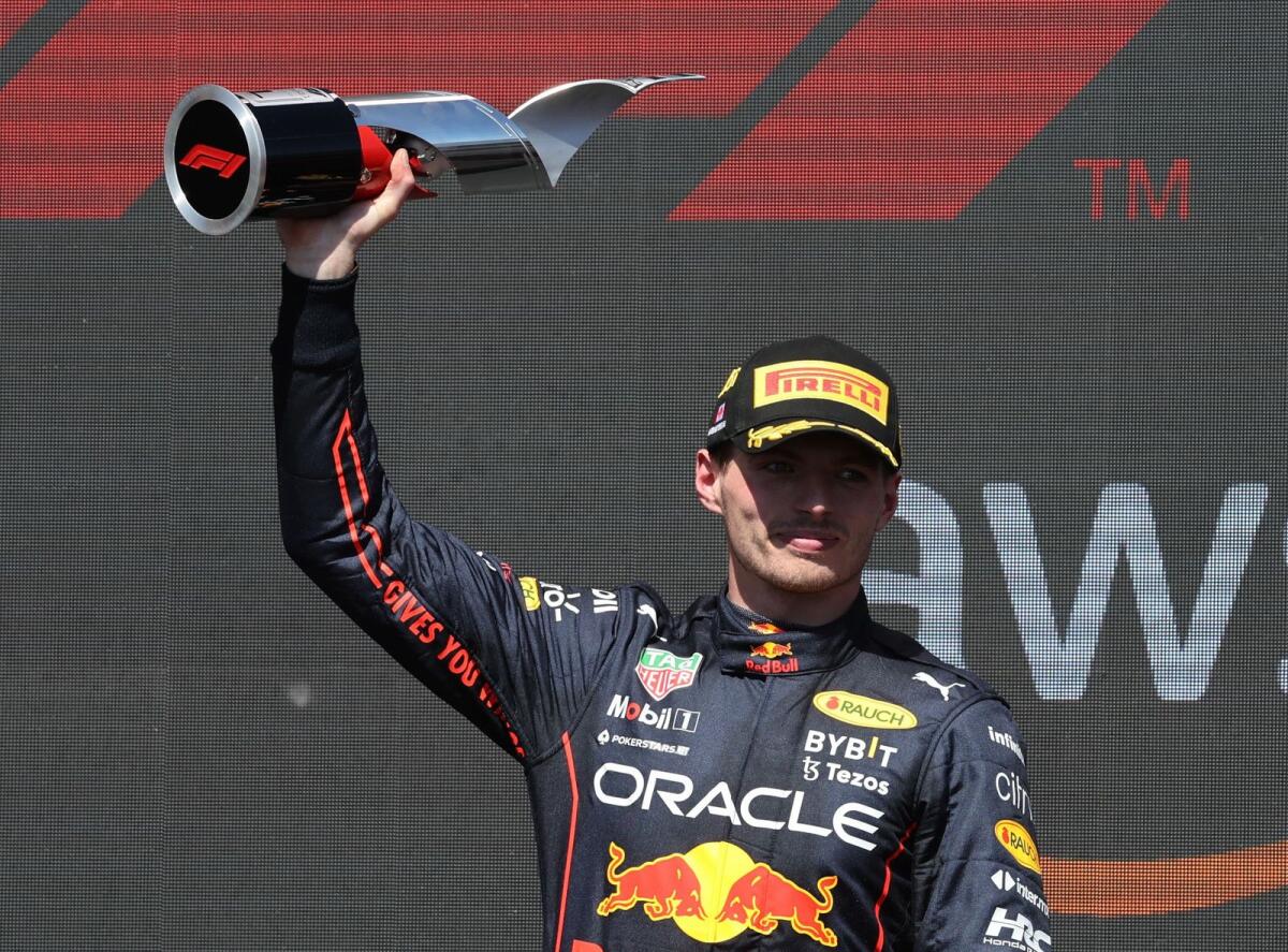 Max Verstappen celebrates with the trophy on the podium. (Reuters)
