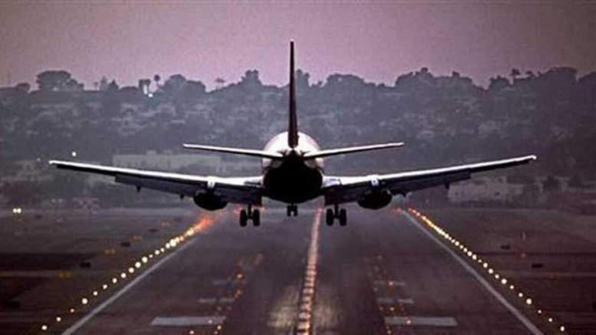 Man late for flight runs behind plane on runway