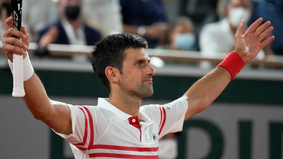 Serbia's Novak Djokovic reacts as he defeats Spain's Rafael Nadal during their semifinal match of the French Open. — AP