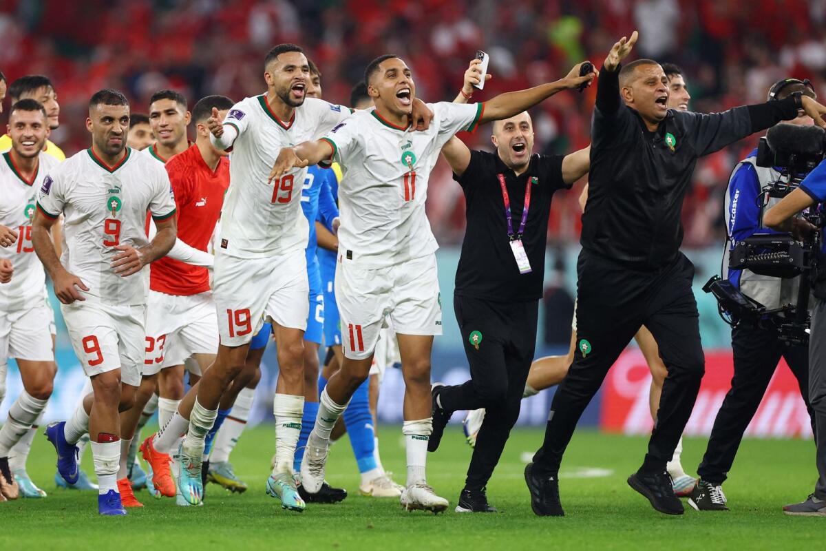 Morocco players celebrate qualifying for the knockout stages. Photo: Reuters