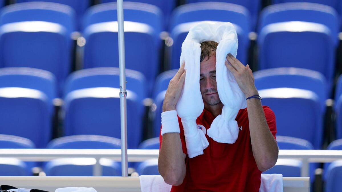 Daniil Medvedev, of the Russian Olympic Committee, cools off during a changeover in a tennis match against Alexander Bublik, of Kazakhstan. — AP