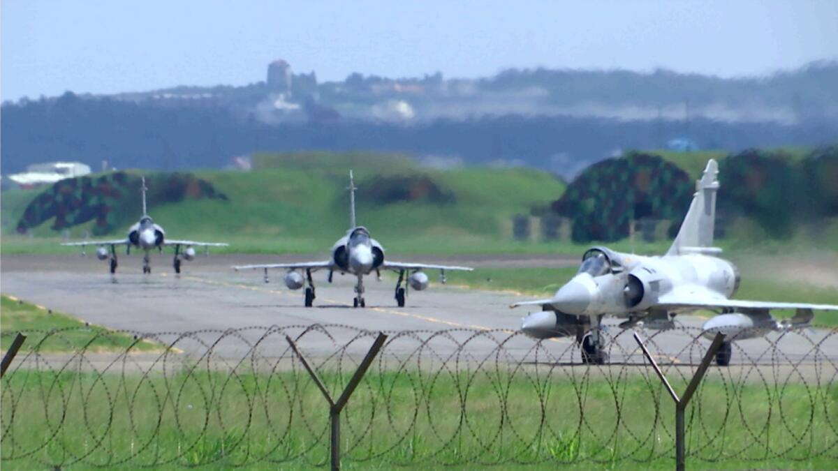 Taiwan Air Force Mirage fighter jets taxi on a runway at an airbase in Hsinchu. — AP