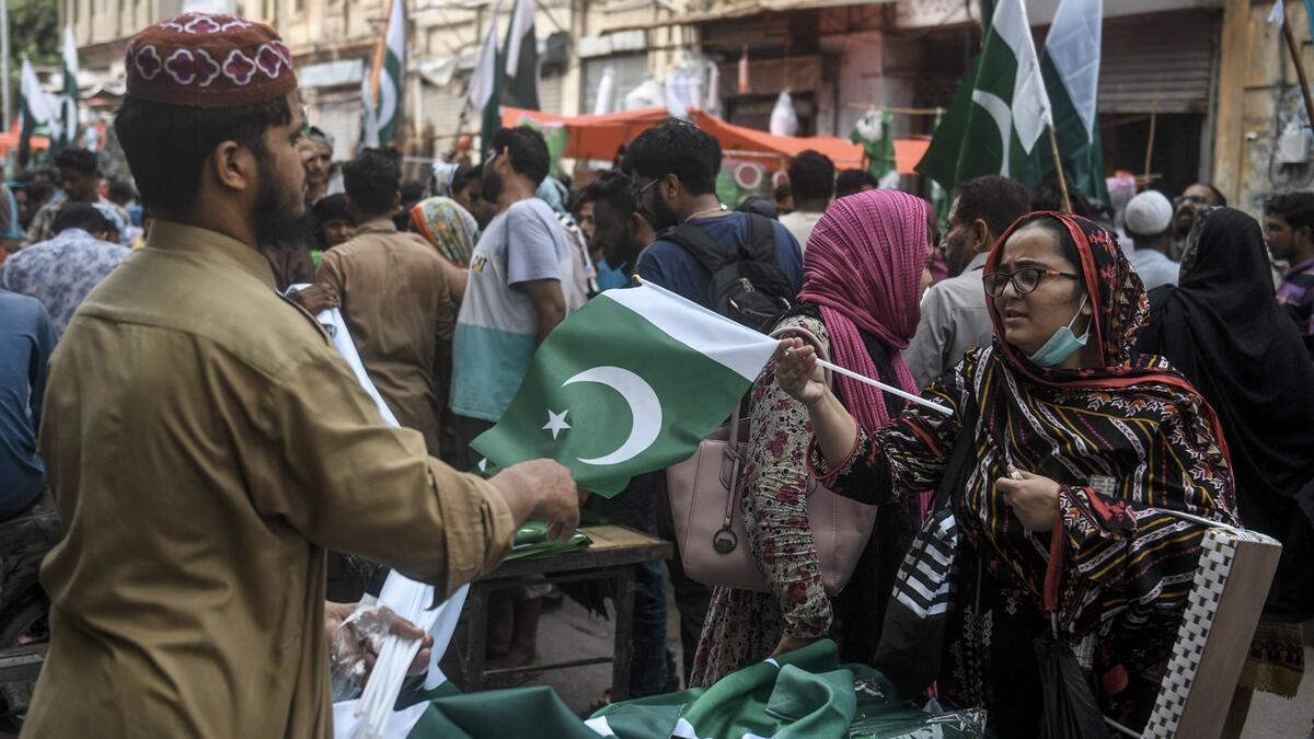 People arrive at a market to buy Pakistani flags in Karachi, ahead of the country's 74th Independence Day.  Photo: AFP