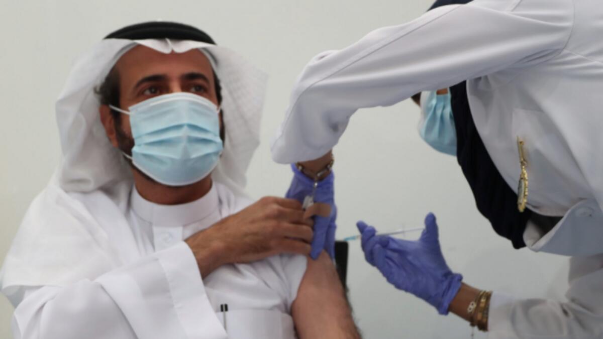 Saudi Arabia’s Minister of Health Dr. Tawfiq al-Rabiah taking the Covid-19 vaccine. Photos: Reuters