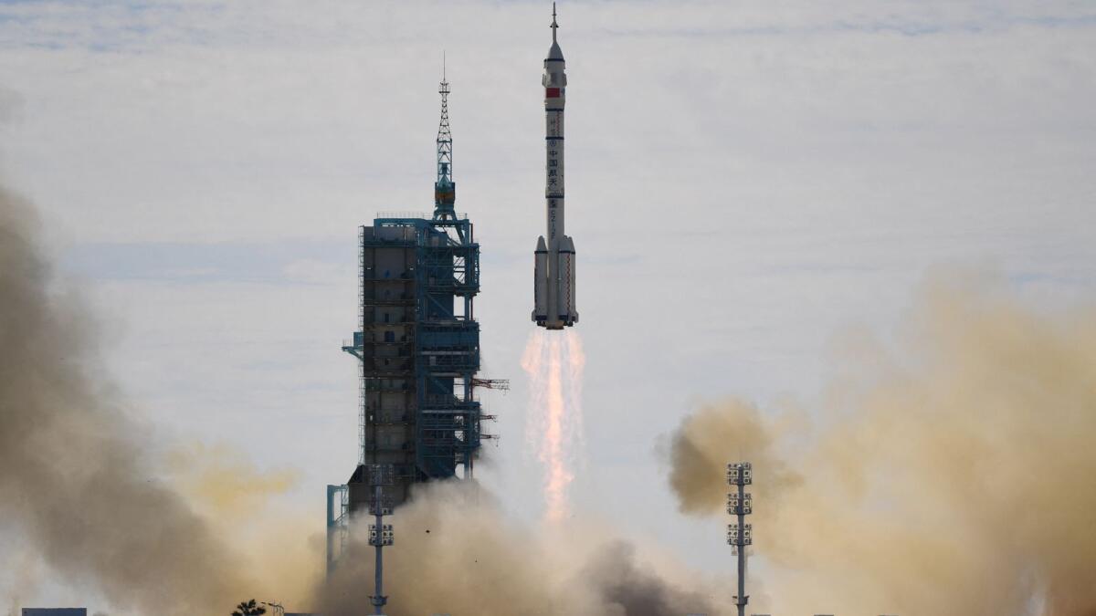 A rocket carrying the Shenzhou-12 spacecraft and a crew of three astronauts, lifts off from the Jiuquan Centre in the Gobi desert in China. Photo: AFP