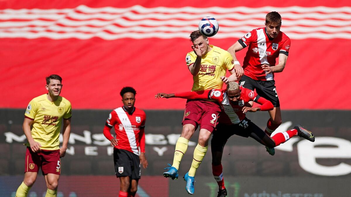 Burnley's New Zealand striker Chris Wood (third right) jumps to head the ball against Southampton's Moussa Djenepo and Jan Bednarek. — AFP