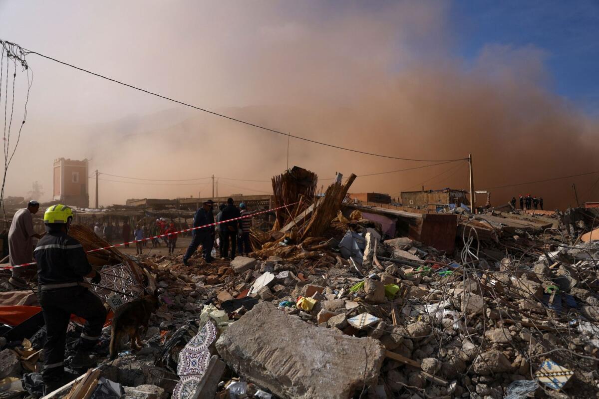 People stand in the rubble in the aftermath of a deadly earthquake in Talat N'Yaaqoub, in Morocco on Tuesday. — Reuters