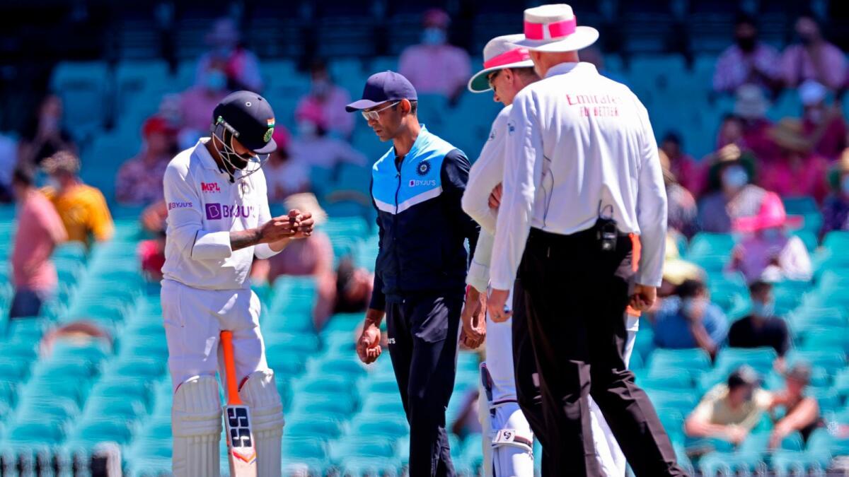 India's Ravindra Jadeja (left) holds his hand after he was hit by the ball on the third day of the third cricket Test match between Australia and India. — AFP