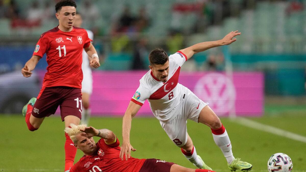 Switzerland's midfielder Granit Xhaka tackles Turkey's midfielder Dorukhan Tokoz during the Euro 2020 Group A  match. — AFP