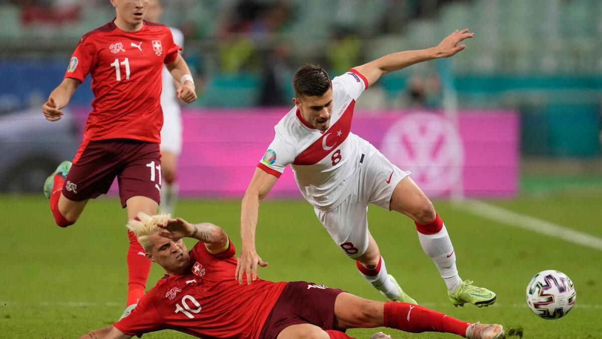 Switzerland's midfielder Granit Xhaka tackles Turkey's midfielder Dorukhan Tokoz during the Euro 2020 Group A  match. — AFP