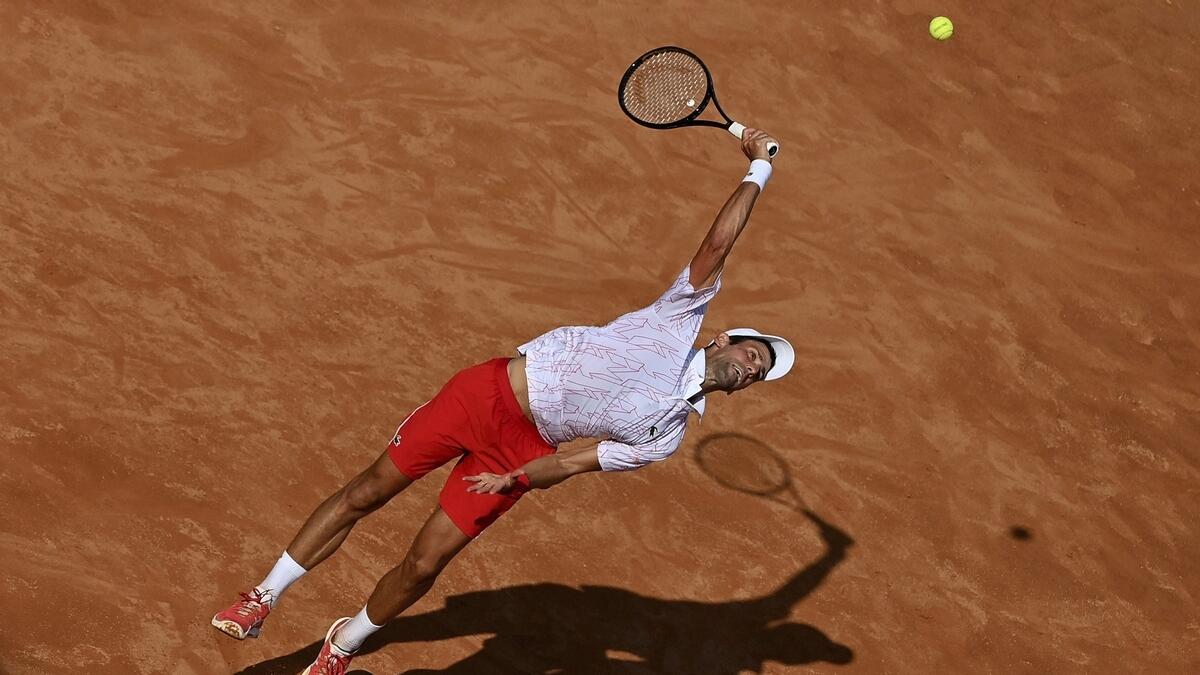Serbia's Novak Djokovic serves the ball to his compatriot Filip Krajnovic during their Italian Open tennis tournament match