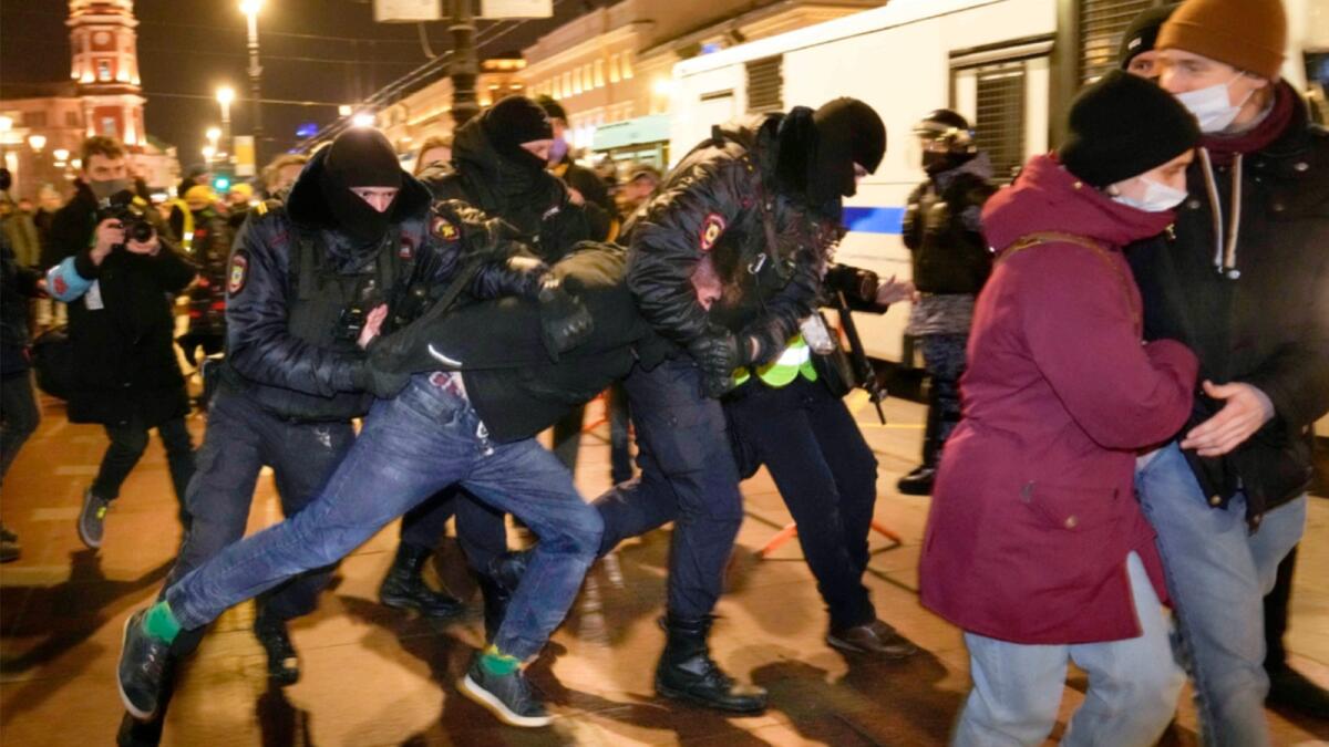 Police officers detain a demonstrator in St. Petersburg, Russia. — AP