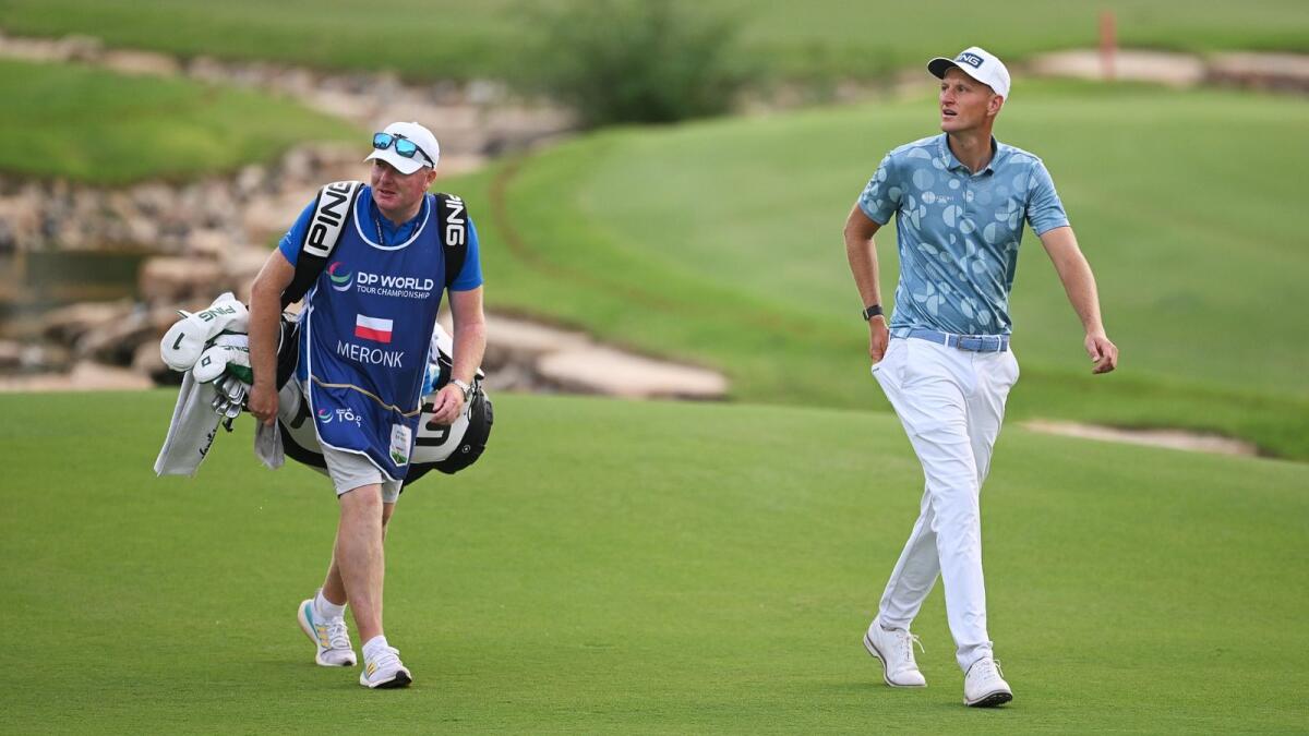Adrian Meronk and caddie on the Earth course at Jumeirah Golf Estates on the DP World Tour. - Supplied photo