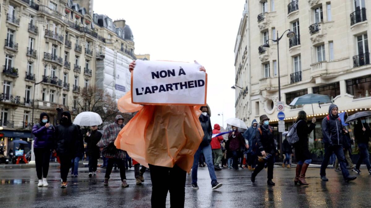 Demonstrators march in opposition to vaccine pass and vaccinations to protect against Covid-19 in Paris. — AP