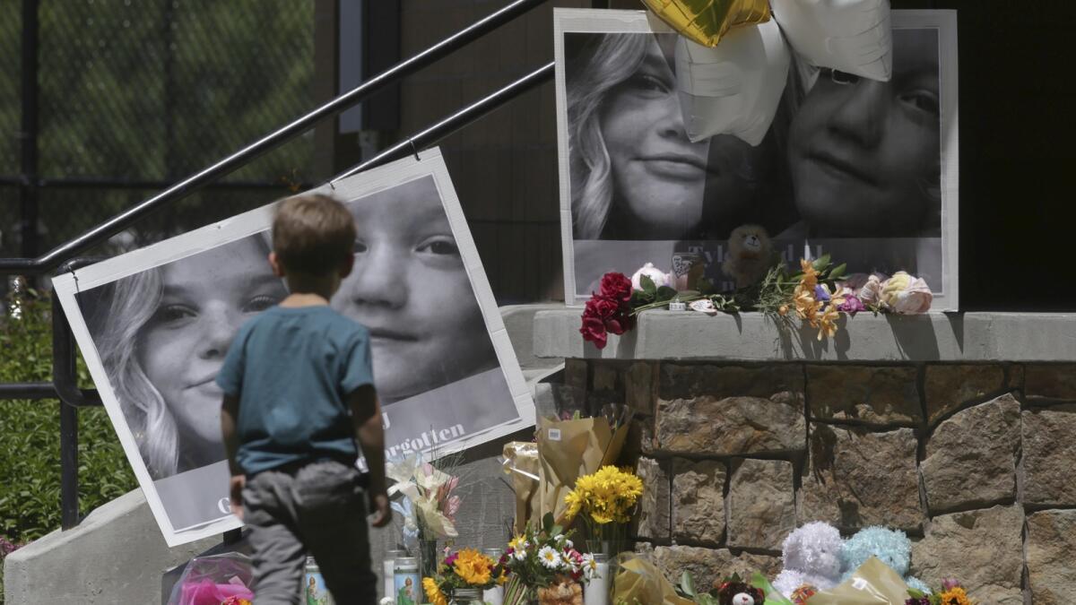 A boy looks at a memorial for Tylee Ryan and Joshua 'JJ' Vallow in Rexburg, Idaho, on June 11, 2020. — AP file