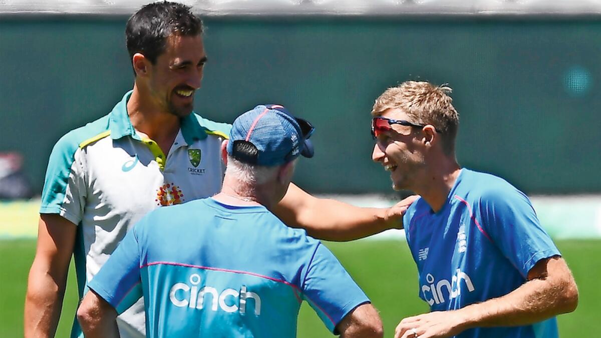 Brothers from another mother: Australia’s paceman Mitchell Starc (left) and England’s captain Joe Root (right) share a joke before the last day’s play of the second Ashes Test in Adelaide. — AFP