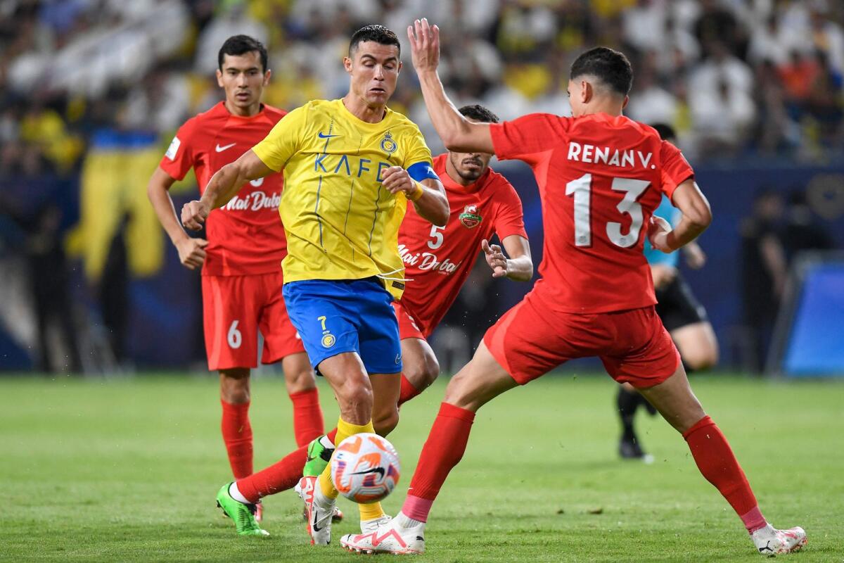 Al-Nassr's Portuguese forward Cristiano Ronaldo vies for the ball with Shabab Al-Ahli's Brazilian defender Renan (right) during the AFC Champions League playoff in Riyadh on Tuesday. — AFP
